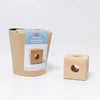 The Grimm’s Cube with Bell (ships in 2-3 weeks), a handcrafted wooden toy, is displayed beside its brown cardboard packaging, which showcases an image and description of the non-toxic baby toy on the front.