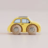 A classic No. 10 GT60 Fifi miniature yellow wooden toy car, made in England, featuring round wooden wheels, black windows, and simple details, photographed on a plain light background.