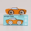 An orange wooden racing toy car rests atop its blue box, which features an illustration of a classic American muscle car along with the text “No. 22 GT125 Cami | Made in England” and “Limited Edition.”.