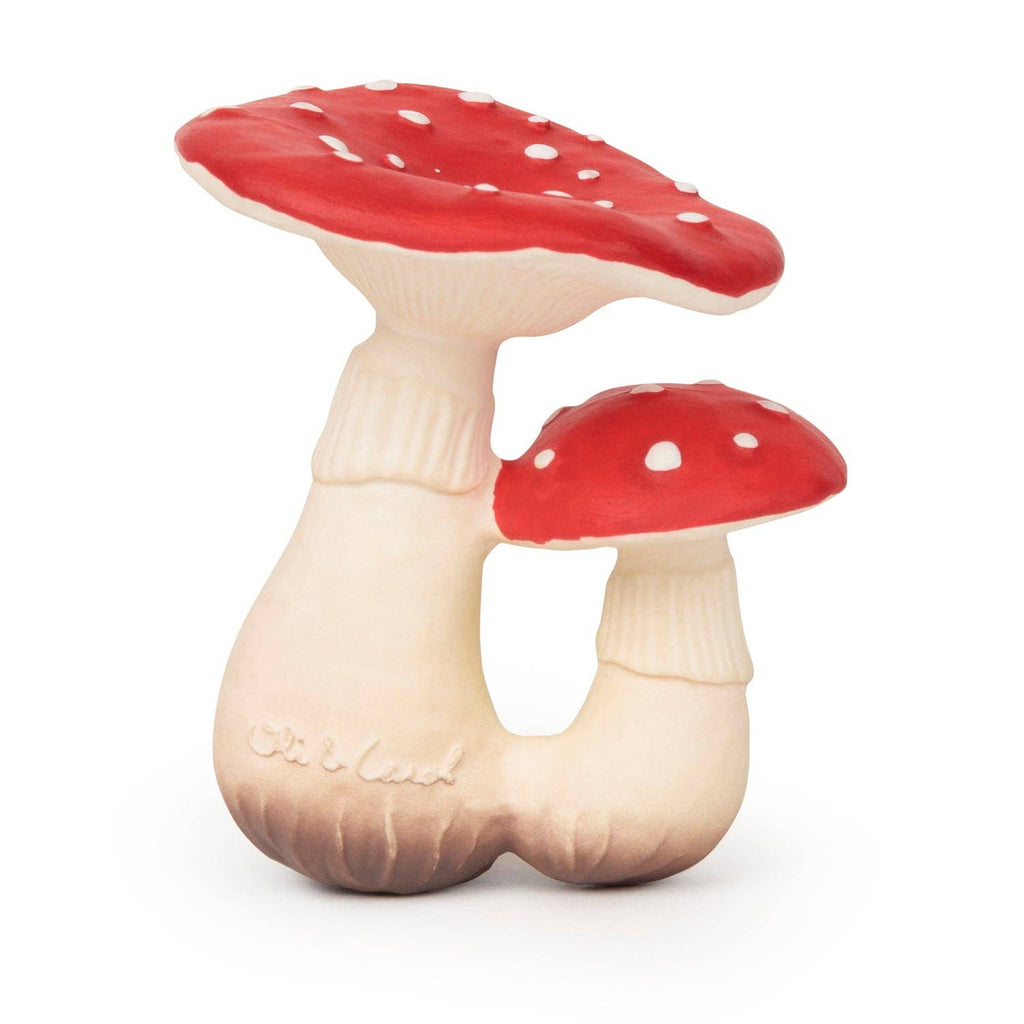 Spot the Mushroom Teething Toy features two red and white spotted mushrooms with cream-colored stems joined at the base. Made from natural rubber, this slightly cartoonish baby toy is perfect for teething and sensory play.