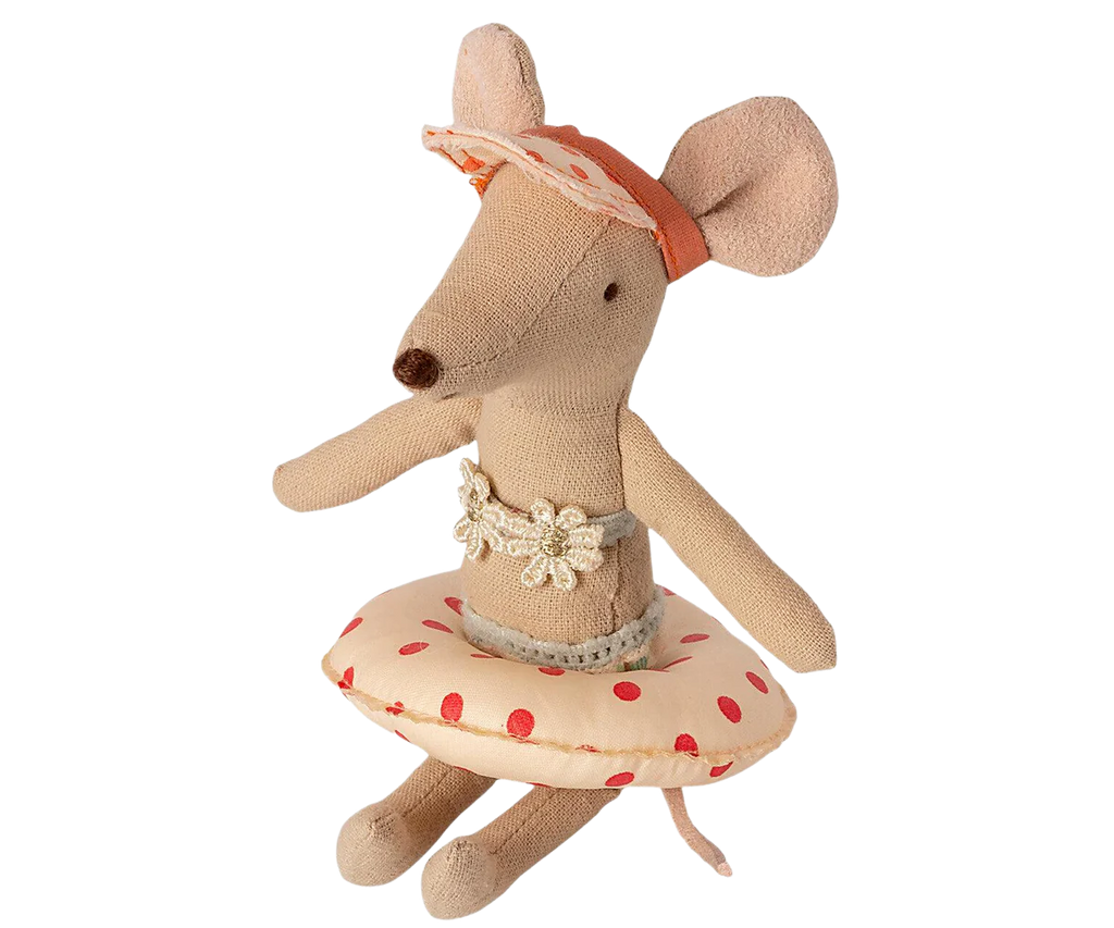 The Maileg Tube, Small Mouse - Red Dot is a charming stuffed toy mouse dressed as a ballerina, featuring large ears, a pointed nose, and a pink headband adorned with lace. This little mouse wears a light pink tutu with red polka dots and is accented by a lacy floral belt. It strikes an elegant pose with its arms and legs extended outward.