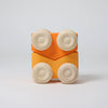 Grimm's Stacking Cars - Orange (coming soon): A minimalist wooden toy with a square orange base and four natural wood wheels, inspired by Grimm's iconic design, displayed on a plain white background.
