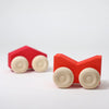 Two Grimm's Stacking Cars - Red (coming soon) with natural wood wheels are on a white surface; one toy car is in focus in the foreground while the second is further back, slightly blurred.