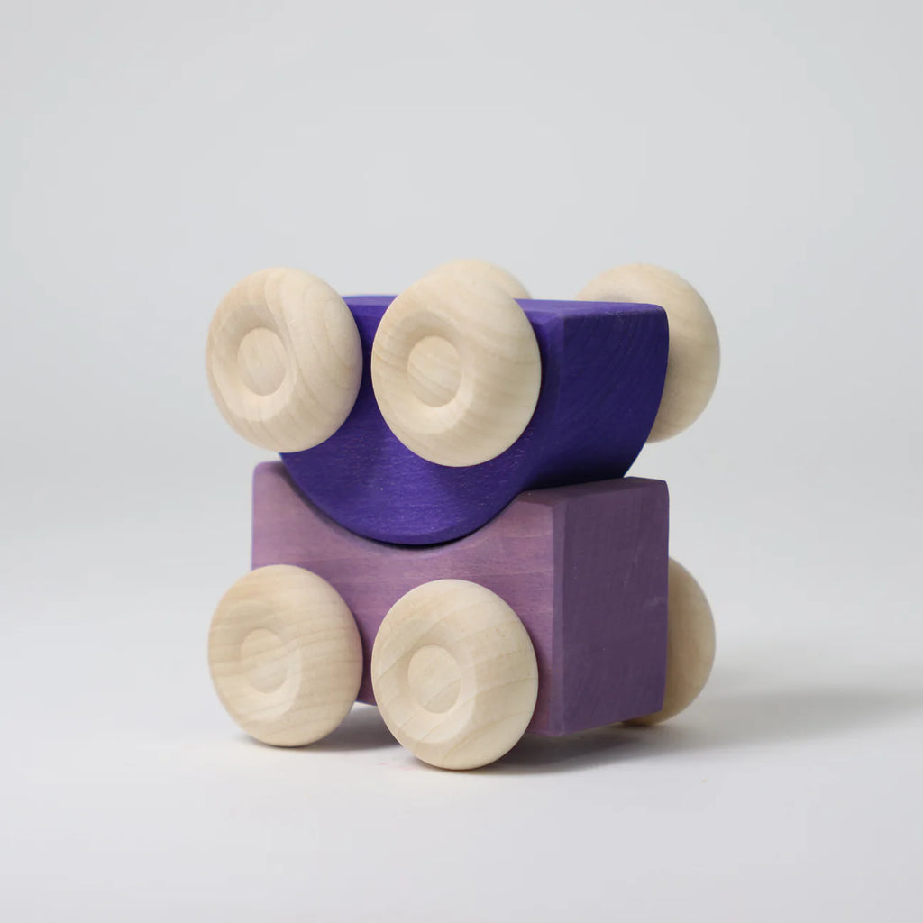 Two Grimm's Stacking Cars - Purple (coming soon), one semicircular and one rectangular, feature purple paint with natural wood wheels and are stacked together on a plain white background—ideal for stacking toy lovers.