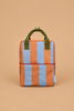 The Sticky Lemon Backpack Medium | Stripes | Cloud Blue + Maple Whirl is a small rectangular backpack featuring vertical orange and blue stripes, green handles, and a white tag, crafted from recycled PET bottles with a waterproof lining and displayed on a light brown background.