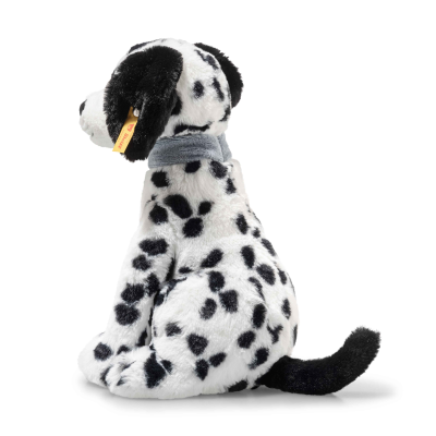 The Steiff Oskar Dalmatian Dog is an 11-inch plush stuffed animal with black spots, a black tail, a gray collar, and a yellow tag on its left ear. It sits upright facing left.