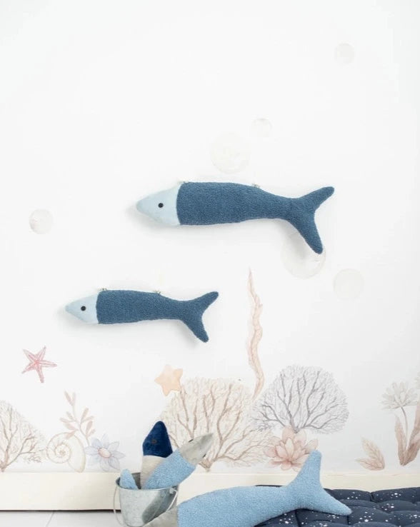 Two Dark Blue Fish Pack plush toys in shades of blue mounted on a wall decorated with painted marine motifs including bubbles, starfish, and seaweed, perfect for children's bed decoration.