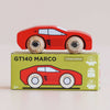 A No. 25 GT140 Marco wooden racing car in red is displayed atop a coordinating green box labeled “GT140 MARCO,” which highlights eco-friendly icons and an illustration of this classic, England-made toy car.