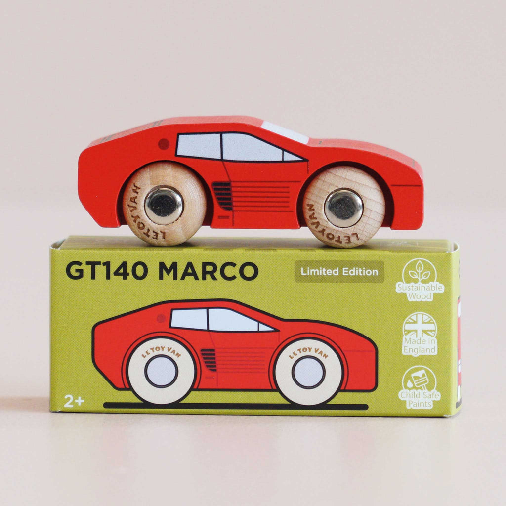 A No. 25 GT140 Marco wooden racing car in red is displayed atop a coordinating green box labeled “GT140 MARCO,” which highlights eco-friendly icons and an illustration of this classic, England-made toy car.