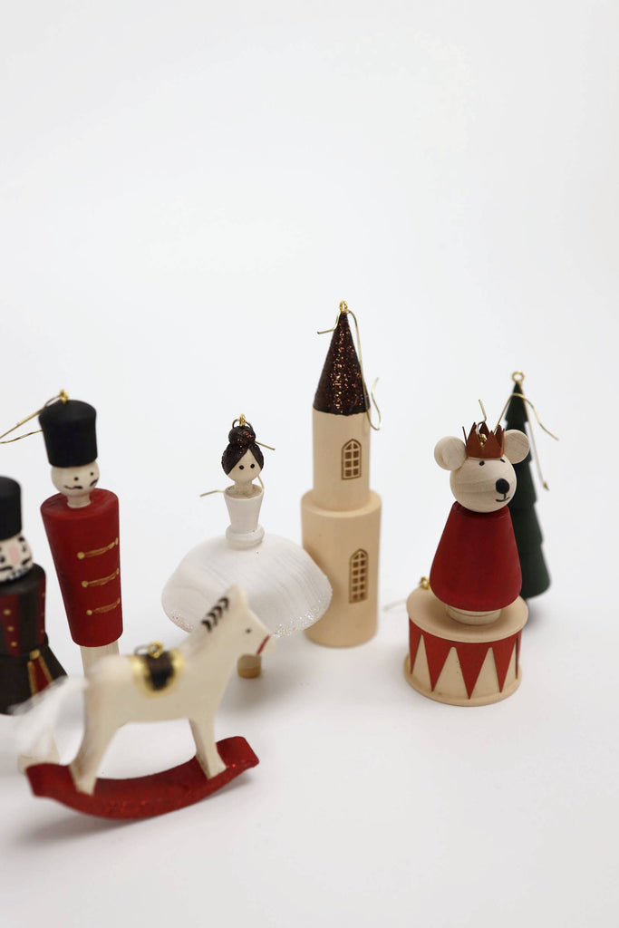 Sabo Concept Christmas Ornaments: a hand-painted wooden set featuring a ballerina, toy soldier, castle, mouse king, rocking horse, and tree—beautifully arranged on a white background.