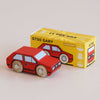 A small red wooden toy car sits beside a yellow box labeled “No. 8 GT50 Gary | Made in England,” featuring an illustration of the same car. The box displays “Limited Edition” along with eco-friendly icons, underscoring the vintage charm and retro cool appeal of this wooden car collectible.