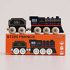 A wooden toy train and coal car rest atop an orange box labeled “No. 49 GT295 Francis | Made in England.” Evoking the charm of classic locomotives, both the train and the box showcase coordinated black, gold, and red designs, with “LTV RAILWAYS” displayed on each train piece.