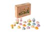 The Grapat Play Set - Flower Meadow features colorful, hand-painted wooden flowers and mushrooms for imaginative play, displayed before a brown box with wildflower illustrations and labeled "Flower Meadow.