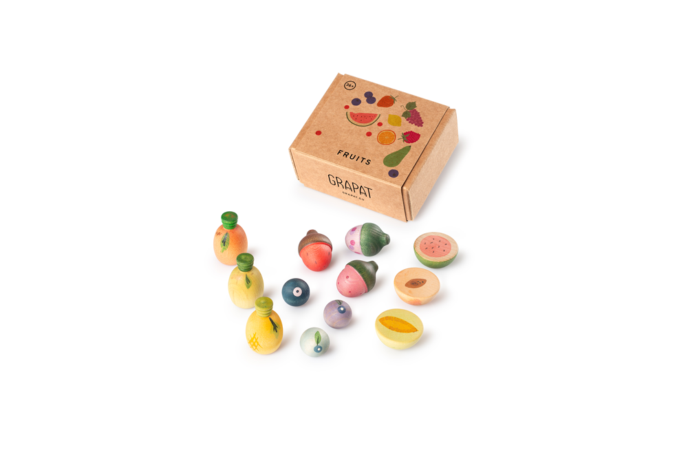 The Grapat Play Set - Fruits features colorful, hand-painted wooden fruits displayed beside a brown box labeled "FRUITS" with playful illustrations and the Grapat brand—ideal for open-ended play.