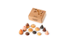 A set of small, colorful, cone-shaped sustainable wooden toys from the Grapat Play Set - Bakes is arranged in front of a brown cardboard box labeled "BAKES GRAPAT" on a white background.