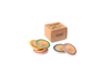 The Grapat Play Set - Dishes features six colorful wooden plates with painted edges and a leaf design, ideal for symbolic play. Displayed beside a brown cardboard box labeled "GRAPAT toys.