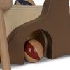 Close-up of a Wooden Hammer Game - Sea Lion featuring a red and natural wood ball partially nestled inside a brown curved structure, with light wood elements visible.