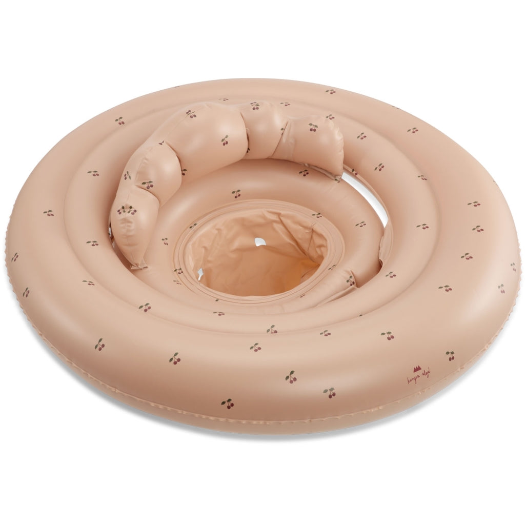 A peach-colored Inflatable Baby Swim Ring - Blush Cherry with a circular design, featuring a backrest for support and decorated with small, scattered paw prints. Made from durable PVC, this float is perfect for babies aged 1-2 years and has a central area for the baby's legs to dangle in the water.