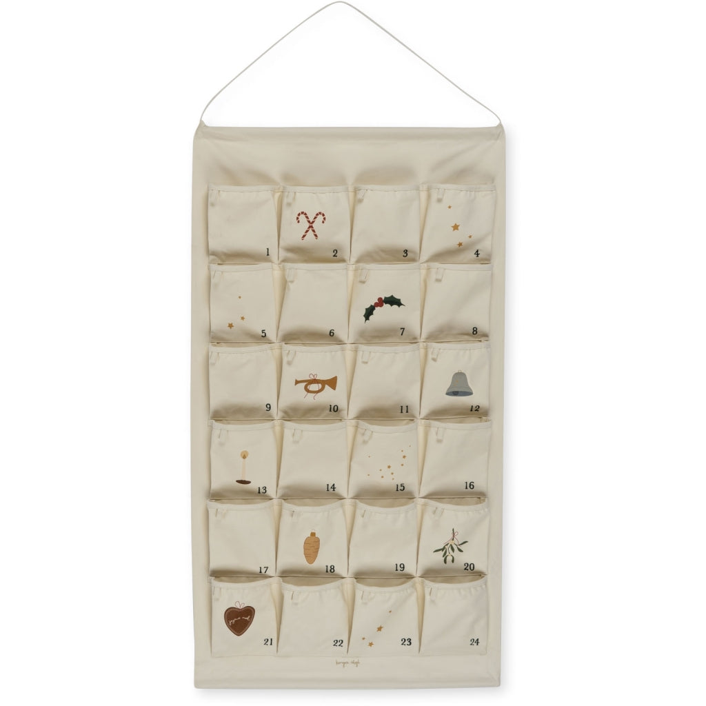 An Noel Christmas Calendar made of organic cotton with 24 numbered pockets, each decorated with simple holiday prints such as a reindeer, mistletoe, and a Christmas tree.