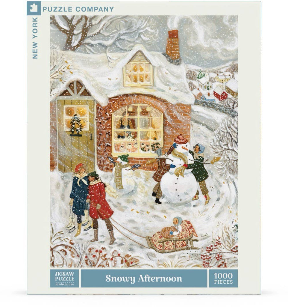 The Nor’easter - 750 Piece Jigsaw Puzzle features artwork of people building a snowman and children playing by a snow-covered brick house on the box.