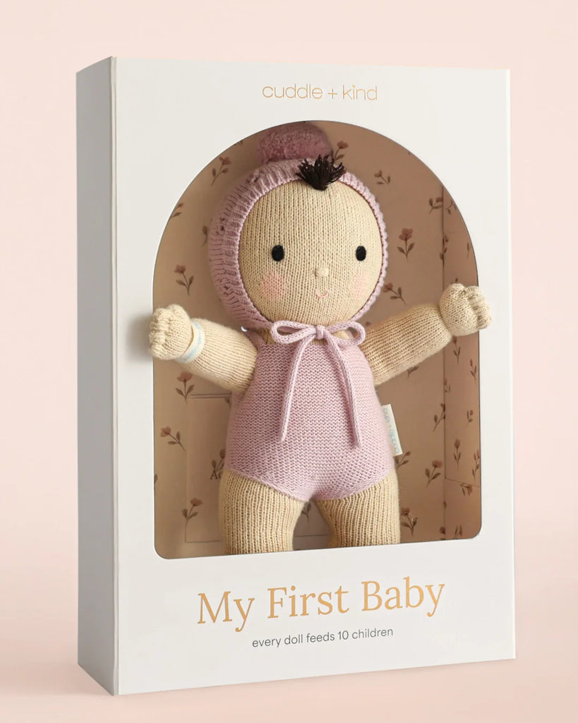 Cuddle + Kind My First Baby (Lavender) ships in one week—each hand-knit doll in a lavender outfit and bonnet comes in a white floral-lined box. Made from natural cotton yarn, every purchase feeds 10 children.