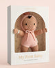The Cuddle + Kind My First Baby (Peach) doll ships in one week. Made from natural cotton yarn, it features brown skin, a pink knit hooded outfit, and a smiling face. Every purchase helps feed 10 children.
