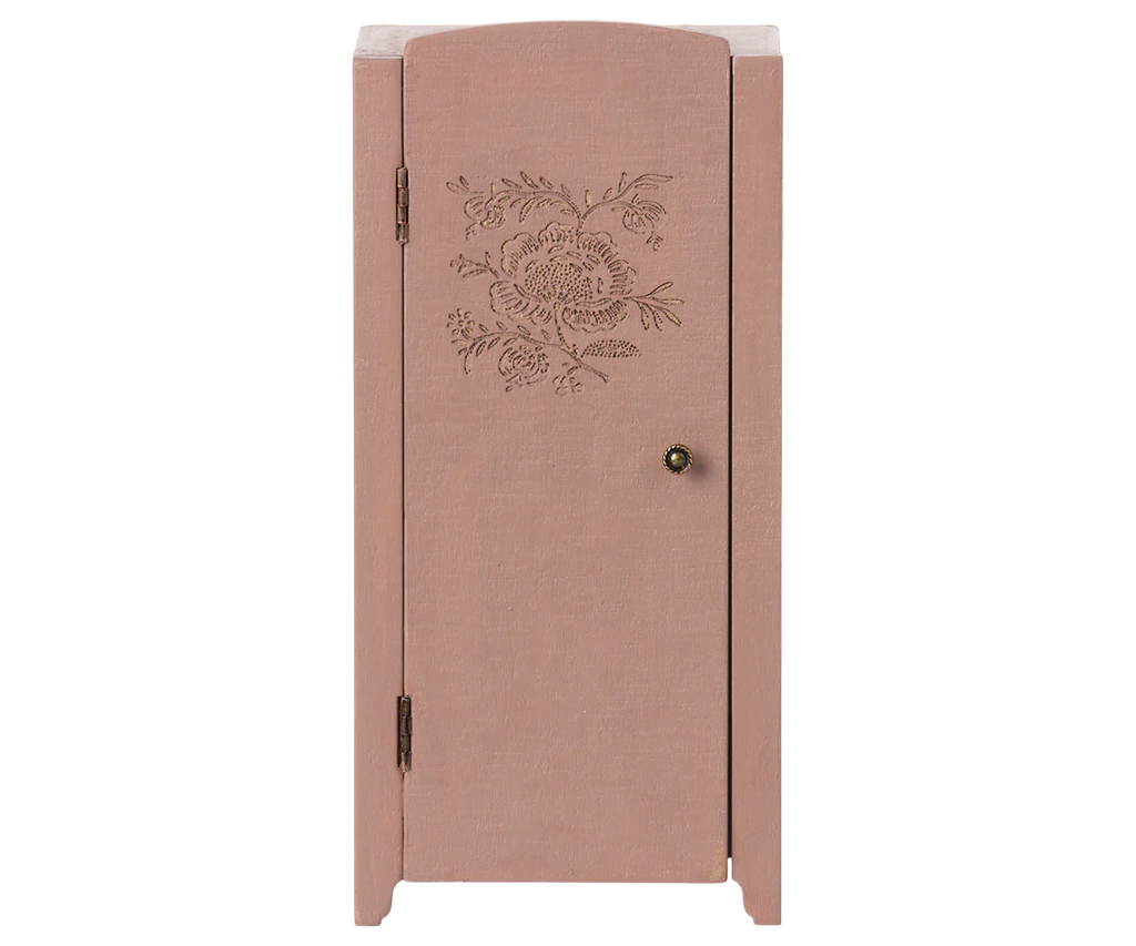 The Maileg Miniature Closet is a small, pink wooden cabinet made from FSC wood. It features a single door with a floral engraving, a round brass knob, and simple lines—perfect for organizing shelves in any space.