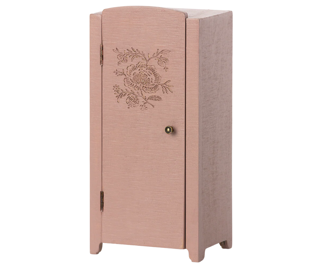 The Maileg Miniature Closet is a small, light pink wooden cabinet made from FSC-certified wood, featuring a single door with floral engraving, round knob, and sturdy legs.