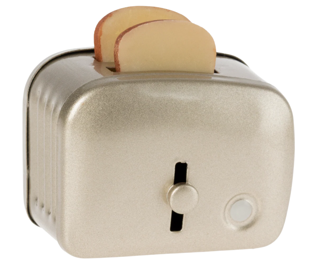 The Maileg Toaster with Bread, Large Size - Silver, is a metallic children's kitchen toy featuring two toy bread slices popping out. Viewed at an angle, its front lever and round button are clearly visible.