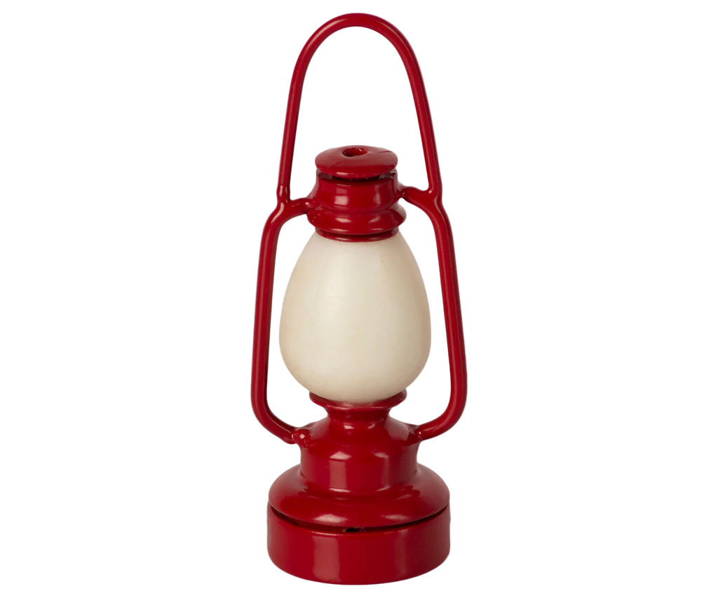 The Maileg Gingerbread House Christmas Set features a red lantern-shaped design with a cream central section, handle, and rounded base, isolated on a white background.