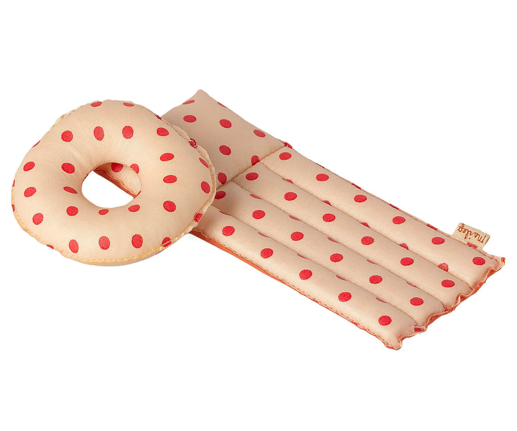 Introducing the Maileg Beach Float, Mouse - Red Dot: a small beige pet bed adorned with red polka dots. It features a rectangular mat paired with a matching round donut-shaped pillow. The soft fabric provides a cozy resting place for your pet, while the coated material ensures durability and maintains comfort.