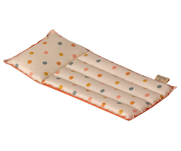 A rectangular beige Maileg Beach Float for mice, adorned with a vibrant polka dot pattern in shades of red, green, yellow, and orange is pictured. The float has a quilted design with several horizontal stitched lines dividing it into sections. Made from durable coated fabric, it features a small fabric tag on one edge.