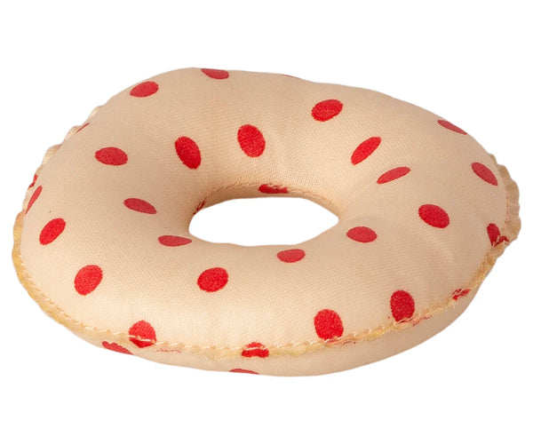 The Maileg Tube, Small Mouse - Red Dot is a soft fabric doughnut toy in beige, decorated with charming red polka dots. Slightly plush and featuring a hole in the center to mimic the classic doughnut shape, this delightful toy is perfect for little mice to enjoy.