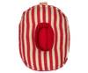 The Maileg Rubber Boat, Small Mouse - Red Stripe is a soft, oval-shaped toy with red and beige stripes and a central red opening, frayed edges, and a fabric tag—perfect as an accessory for Maileg mice.