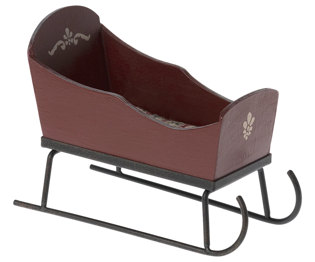 The Maileg Sleigh, Mouse - Red is a small wooden sleigh with hand-painted red details and black curved metal runners.