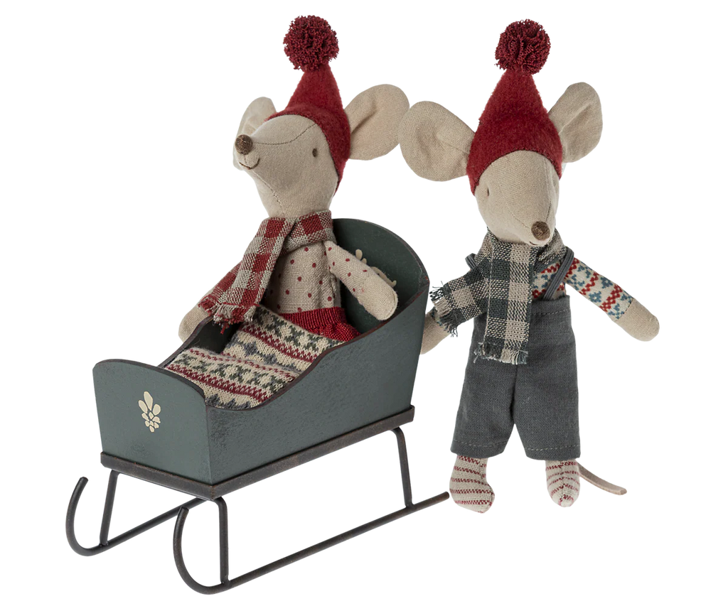 The Maileg Sleigh, Mouse - Green features two mice in red hats and winter clothes, making it a charming accessory for dollhouse furniture or festive displays.