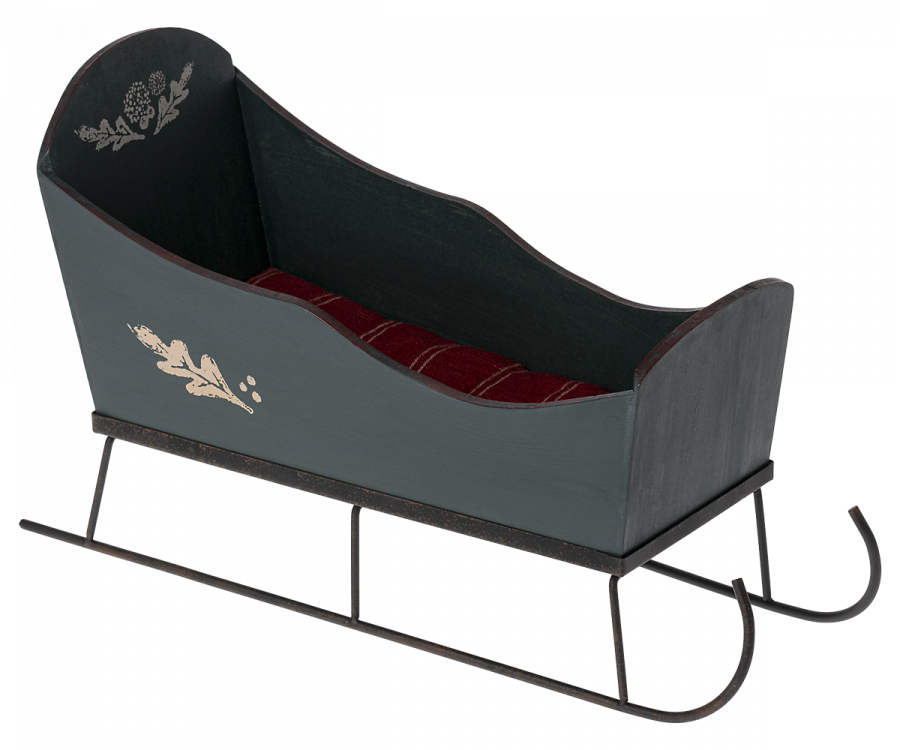 Maileg Christmas Medium Sleigh - Green painted green with hand-painted floral details on the sides, containing a soft red plaid cushion. The sleigh has curved metal runners and is designed in a vintage style, likely used for ornamental purposes or home decor.