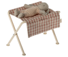 Maileg Nursery Table, Micro - Red Checker with a pink and white checkered seat is shown holding a stuffed rabbit doll in pink knit clothes, resembling cute baby furniture against a plain background.