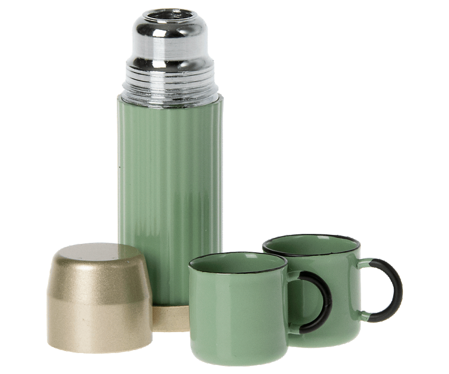 A Maileg | Miniature Thermos And Cups with its cap off and two matching green cups, one with a black handle, arranged on a white background.