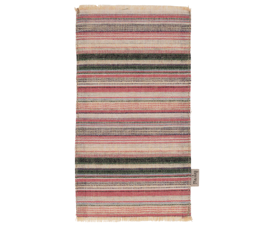 A Maileg Rug - Striped with horizontal stripes in various shades of green, red, beige, and white, with a visible fabric label on the bottom right corner.