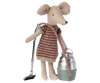 A plush mouse toy dressed in a striped sweater, holding a Maileg Miniature Vacuum Cleaner and carrying a green metal lunch box with a red strap, isolated on a black background. This Maileg Mini Hoover accessory adds