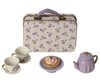 A vintage-style picnic set that includes a Maileg Miniature Afternoon Treat Tea Set - Purple Madelaine, ceramic teapot, and two cups with saucers. In the center, there is a plate with a colorful pastry.