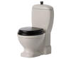 White mini toilet with black lid. 