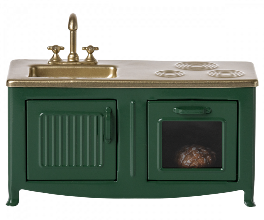 A miniature Maileg Kitchen - Dark Green with a golden countertop, featuring a sink, stove, and an oven with a visible loaf of bread inside.