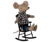A plush mouse doll wearing a plaid shirt and denim jeans, seated on a Maileg Rocking Chair - Anthracite, isolated on a black background.