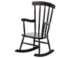 An Maileg Rocking Chair - Anthracite with worn wooden armrests and vertical slat back, isolated on a black background.