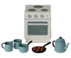 A Maileg Madam Blue’s Favorites, featuring a mini stove, three blue cups, a blue teapot, and a frying pan with four meatballs. The stove has four burners with three control knobs and an oven door. All items are styled in muted colors, predominantly blue and gray.