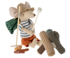 A whimsical Maileg Hiker Mouse dressed as a hiker with a striped shirt, shorts, and hat, equipped with a walking stick and a green backpack, standing next to the Maileg Campfire.