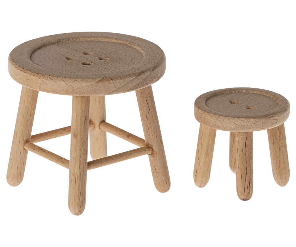 Two small wooden button-like stools complementing the Maileg Afternoon Tea Set, with the larger stool having a four-hole design and the smaller one three holes. Their round tops and straight legs make them perfect for imaginative play spaces.