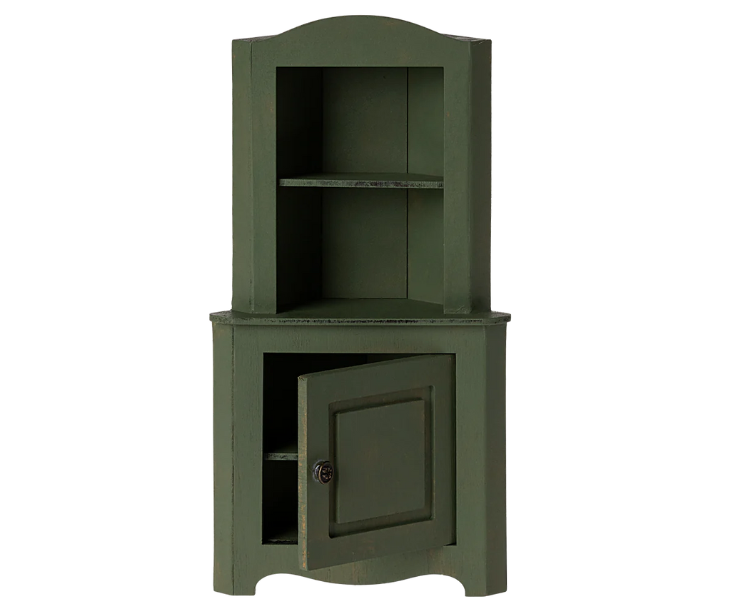 Introducing the Maileg Large Corner Cabinet in dark green - a charming wooden piece designed with an open upper section incorporating two shelves, and a bottom section with a single door slightly ajar to reveal additional storage space within. Ideal for stylish home decoration, this cabinet perfectly blends rustic charm with classic elegance.